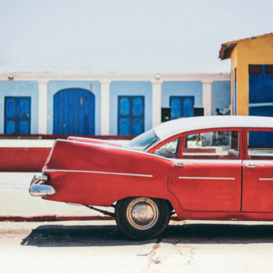 american red classic car 1950s in cuba is featured in this print