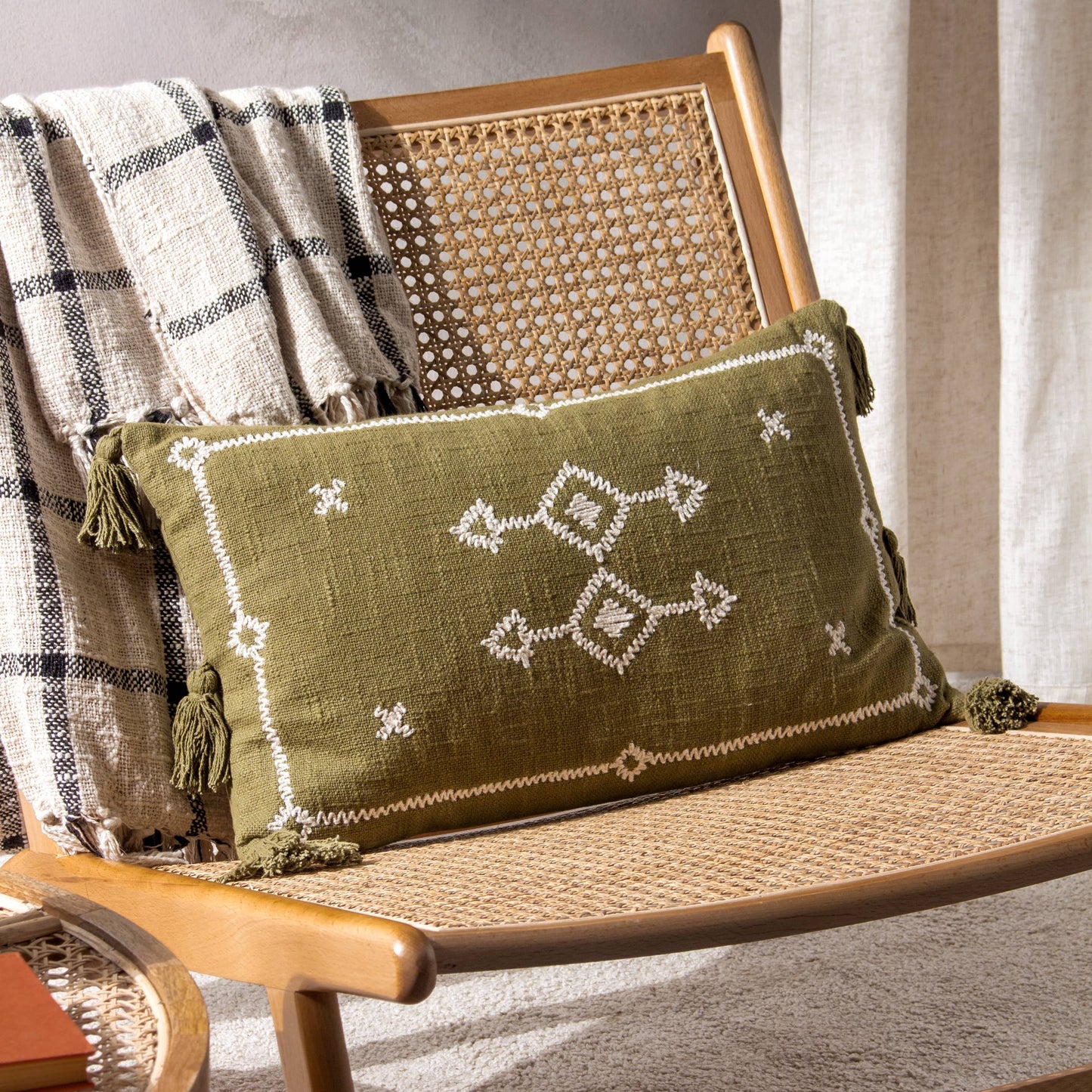 rectangular cushion in khaki with white embroidered design and six tassels 50 x 30 feather filled