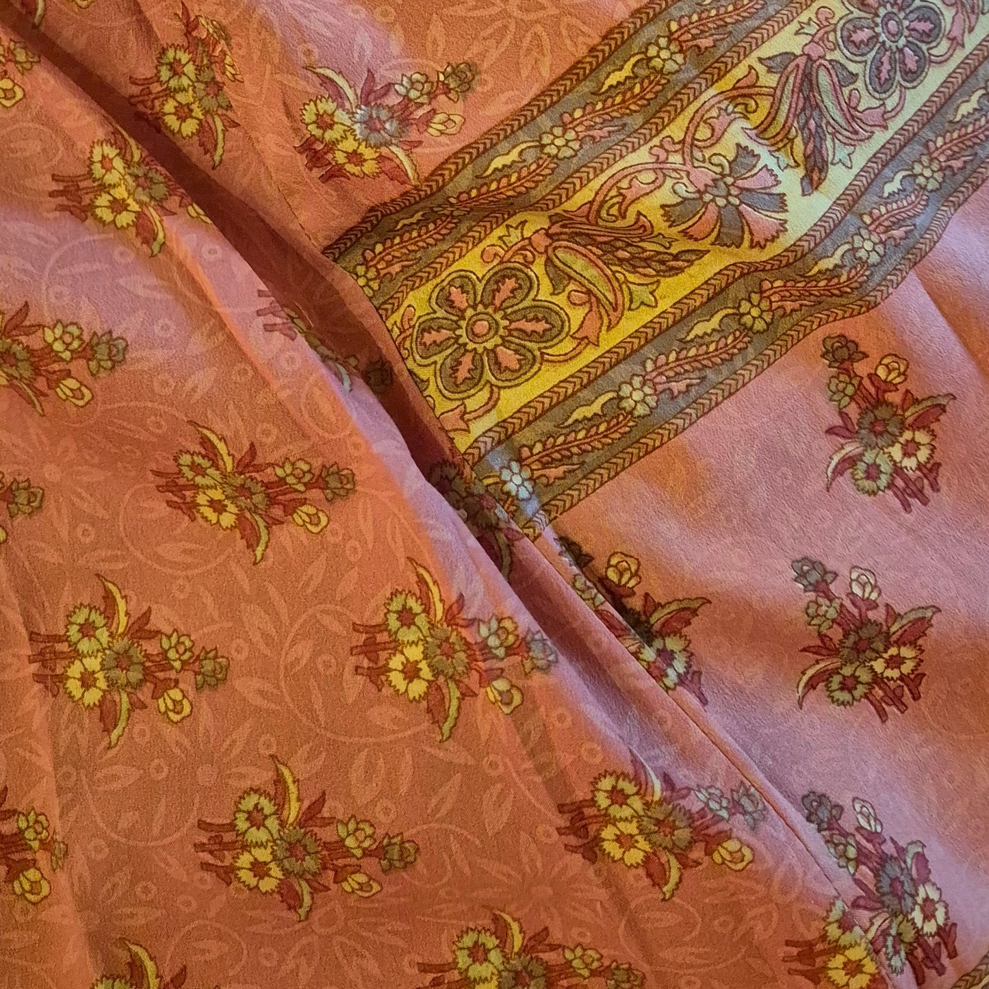 A reversible silk kimono made with vintage up-cycled silk sari fabric. Each side is completely different and each kimono is completely unique