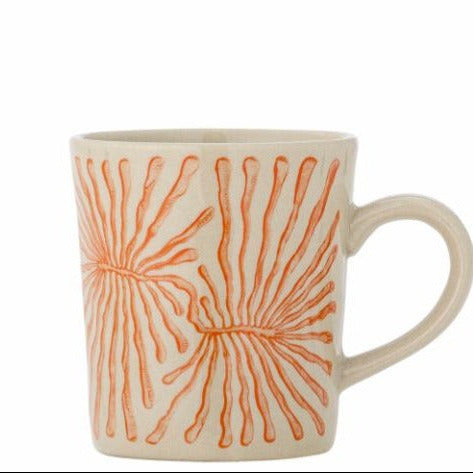 Beige mug with orange abstract pattern on a white background