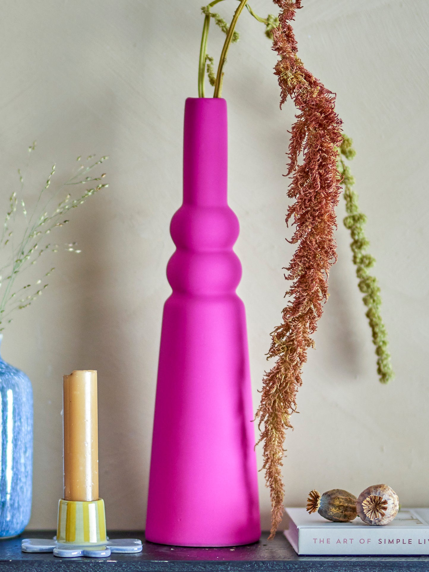 The Isolde Vase. striking in its shape. it is made of stoneware with a soft matte glaze in a deep pink color so as well as looking gorgeous, it feels soft to the touch. Its graphic shape combined with the vase's beautiful color makes it a stunning centerpiece in the room
