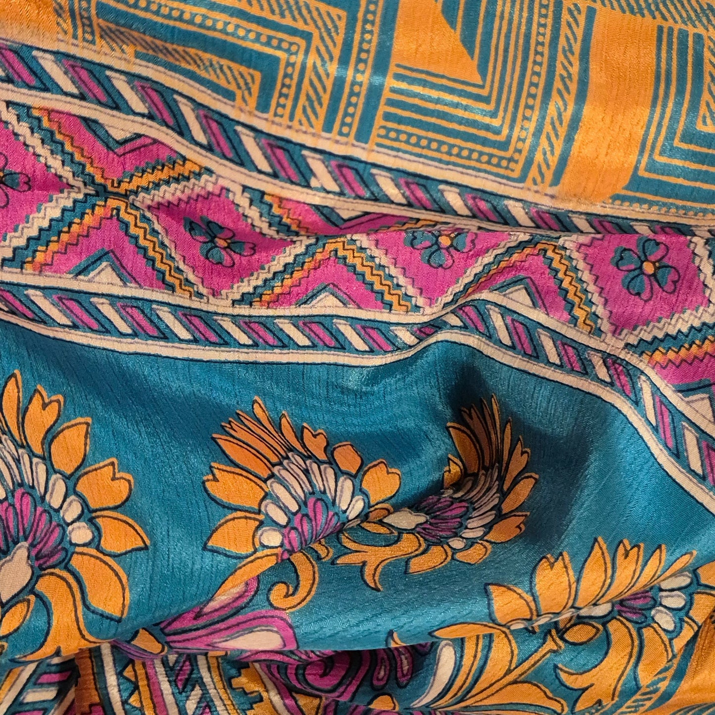 A reversible silk kimono made with vintage up-cycled silk sari fabric. Each side is completely different and each kimono is completely unique