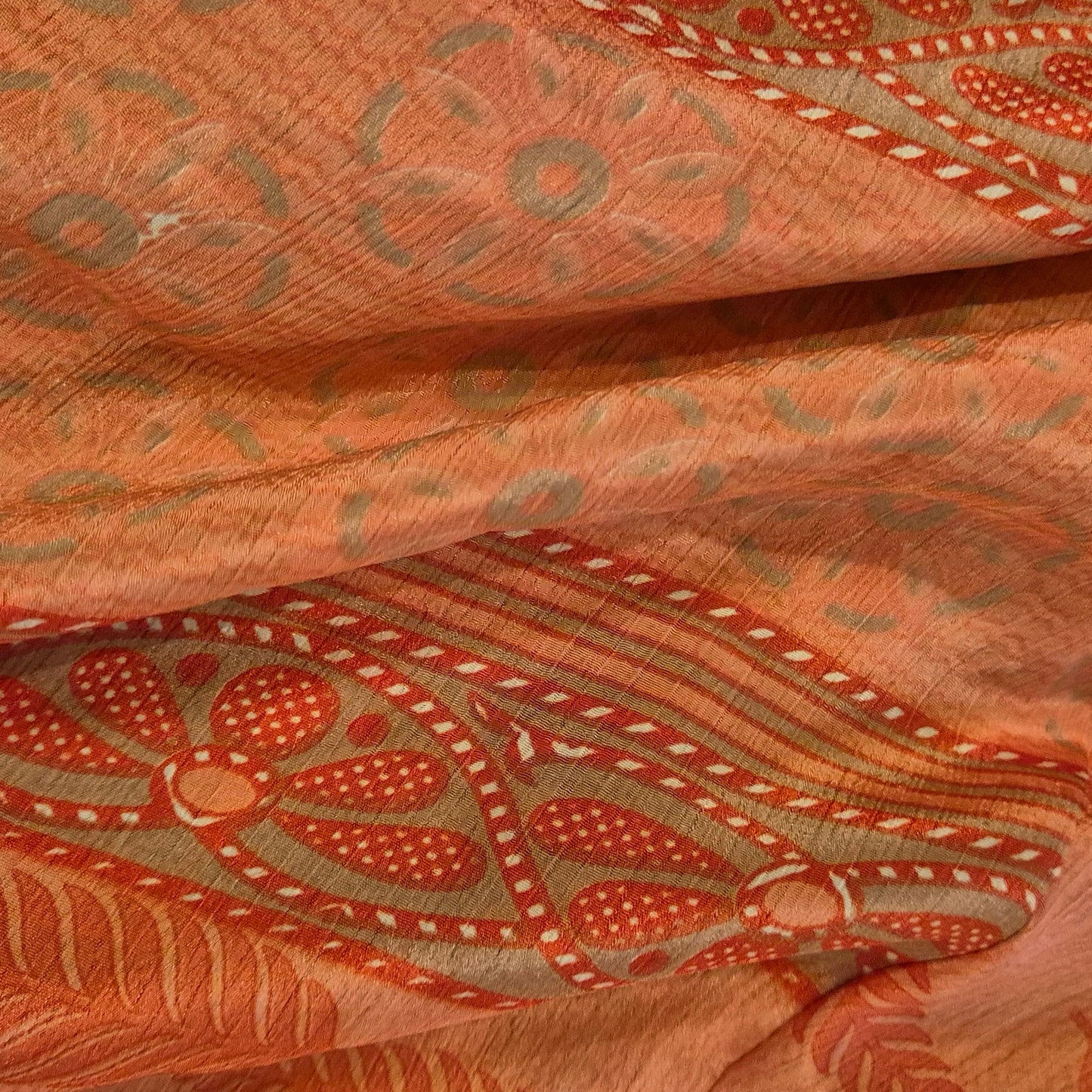 A reversible silk kimono made with vintage up-cycled silk sari fabric. Each side is completely different and each kimono is completely unique