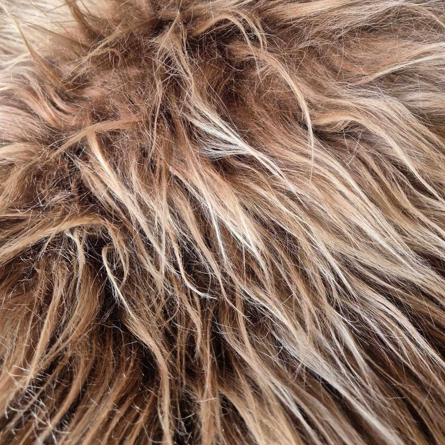 long haired Icelandic sheepskin rug. very luxurious, soft and it comes in a rusty brown with slightly lighter tips. A very bohemian addition to your home