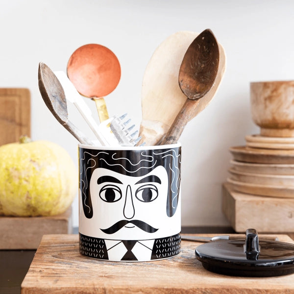 Black and white storage jar with the face of the Mexican man Carlos.