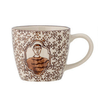 Tom Mug with picture of boy in frame and repeated brown flower motifs