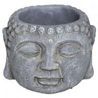 cement plant pot in shape of buddha head with closed eyes 