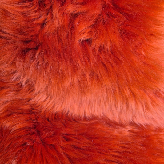 A deep coral orange luxurious sheepskin in medium size