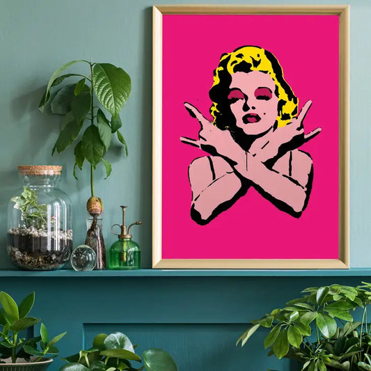A poster of Marilyn Monroe in the Andy Warhol style with a deep pink background 