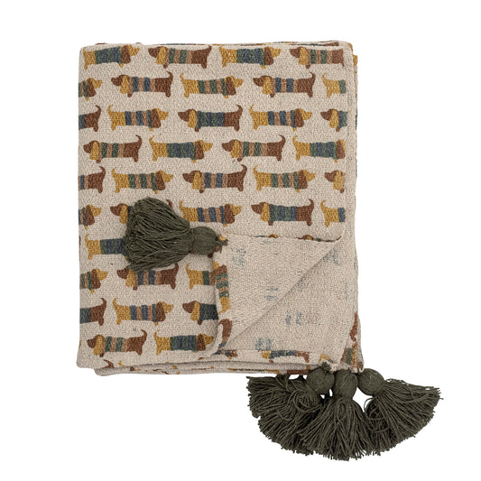 A cotton throw with repete pattern dachshund dogs in stripy jumpers on it and a big tassle on each corner