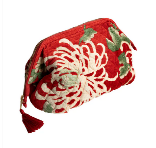 a velvet cosmetic pouch with a floral print on a red background