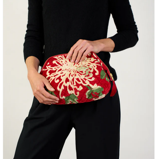 a velvet pouch with zipper floral print on a red background