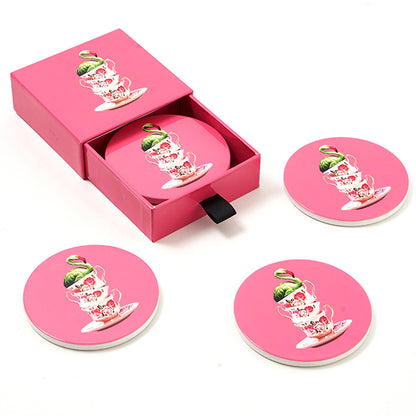 Set of four ceramic coasters in pink depicting three teacups stacked with an exotic bird on top