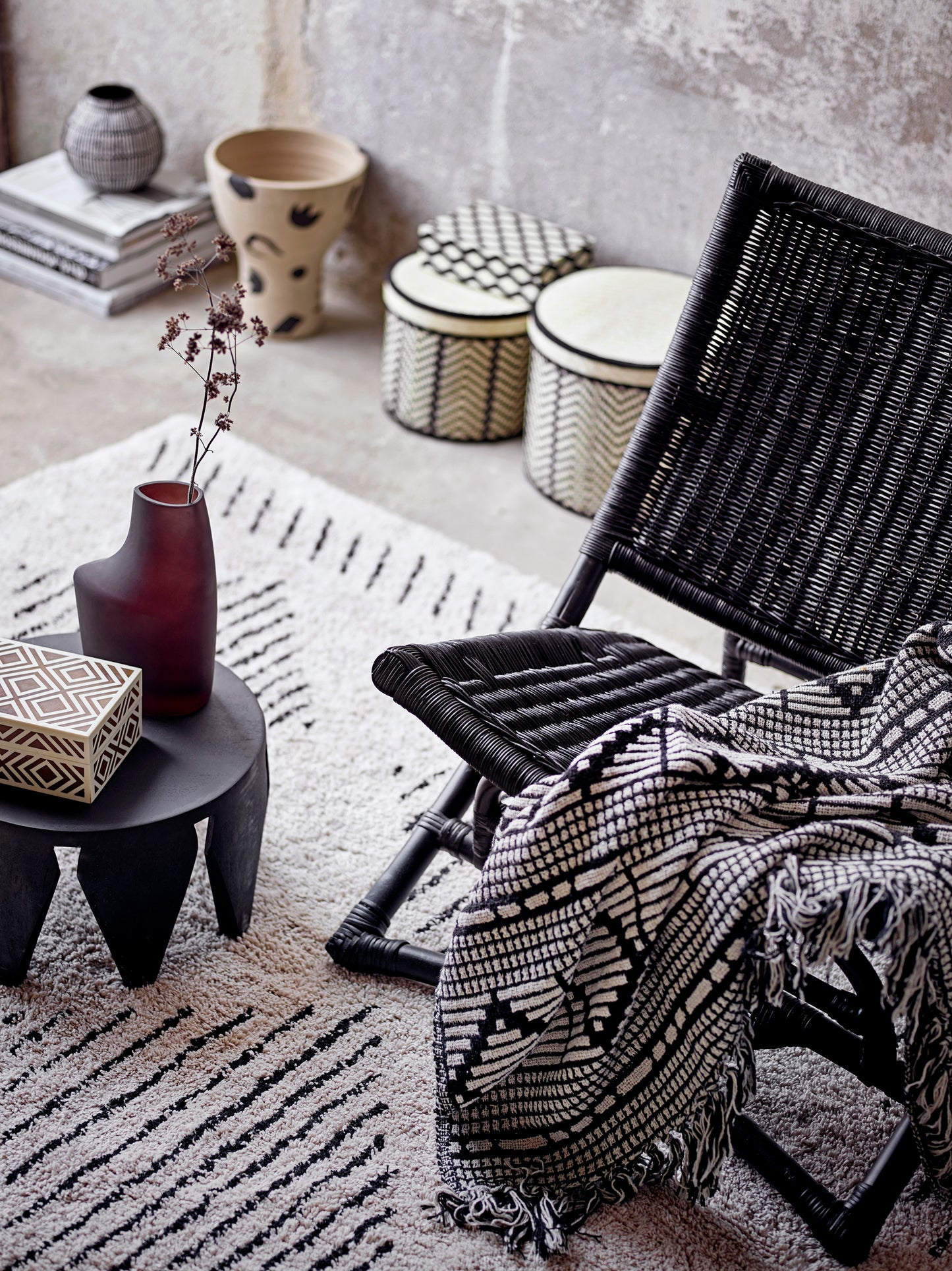 A soft and luxurious throw in gray/green with a decorative pattern and fringe