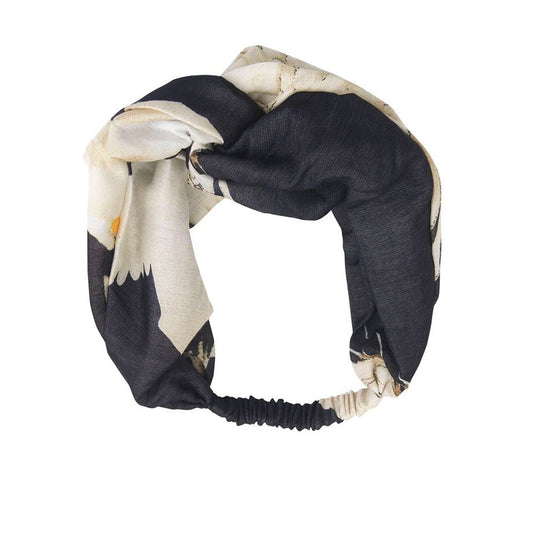 black headband with white stork design