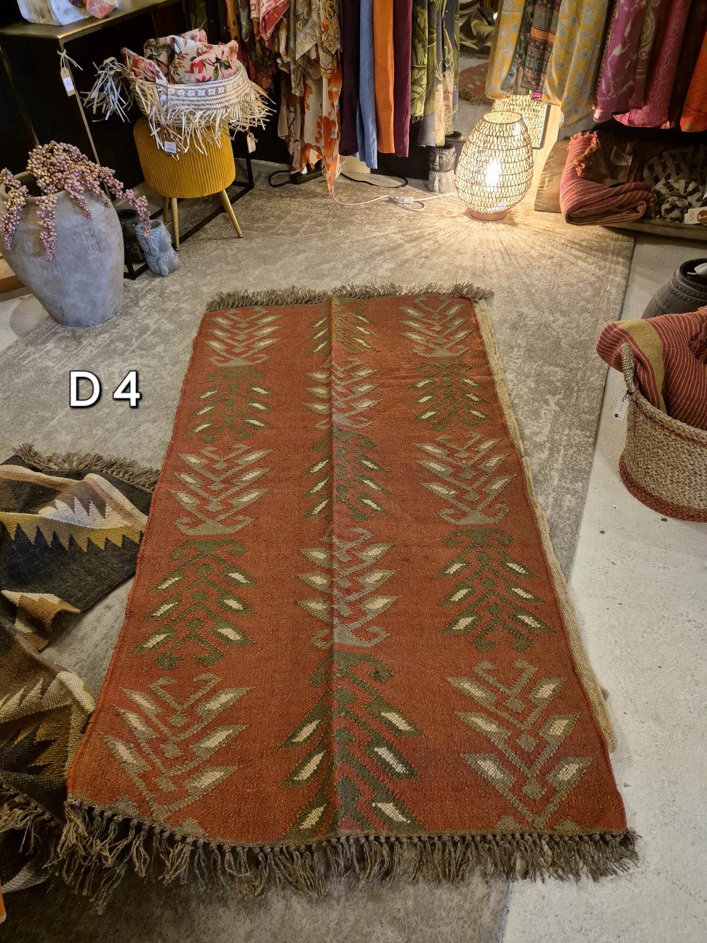 Add a touch of classic elegance to your space with this Kilim Rug (style D4). Handcrafted with jute for a rich and textured look, this rug boasts a beautiful earthy color palette that will bring warmth to any room.