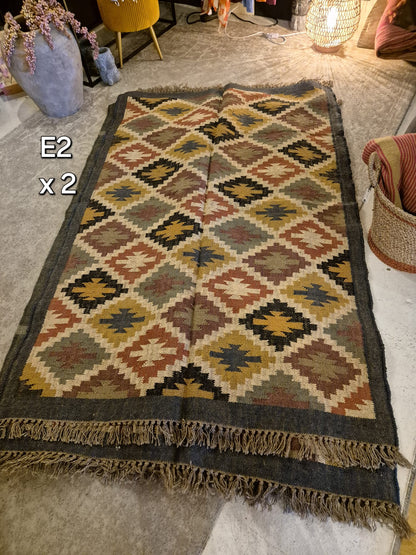 Add a touch of classic elegance to your space with this Kilim Rug (style E2). Handcrafted with jute for a rich and textured look, this 6x4ft rug boasts a beautiful earthy color palette that will bring warmth to any room.