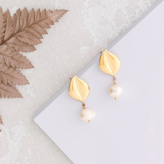 pendant earring with pearl hanging from leaf design
