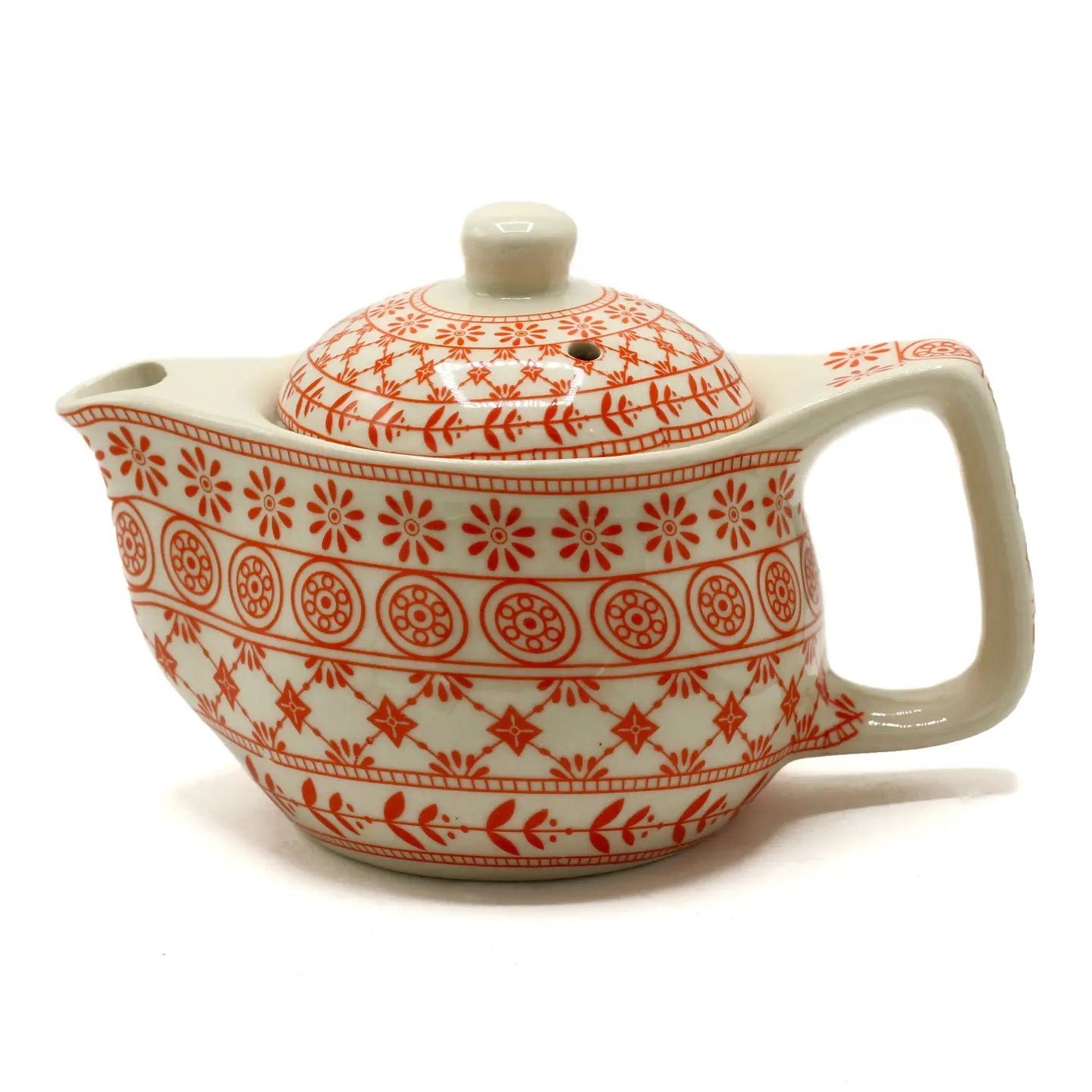 tea pot with red design and strainer