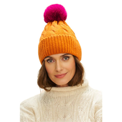 womens bobble hat in tangerine with faux fur pom pom in pink