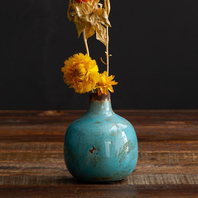 As a small ceramic bud vase in&nbsp; turquoise, this vase is perfect for displaying a single stem or adding a pop of color in a group setting. From its versatile use to its aesthetically pleasing appearance, this vase is sure to enhance any space.