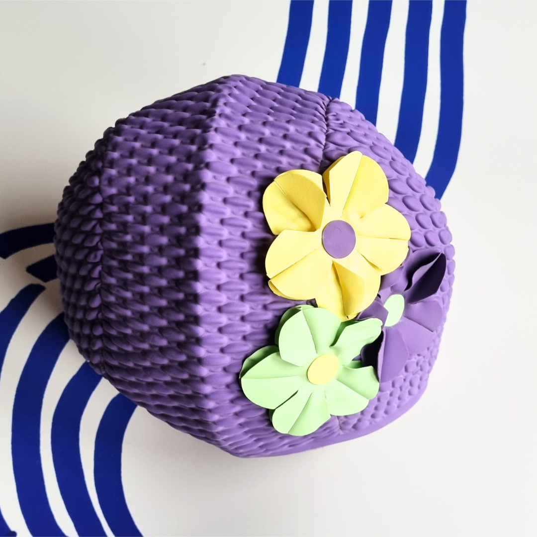 Retro purple swim hat with three flowers on the side, yellow, mint green and purple