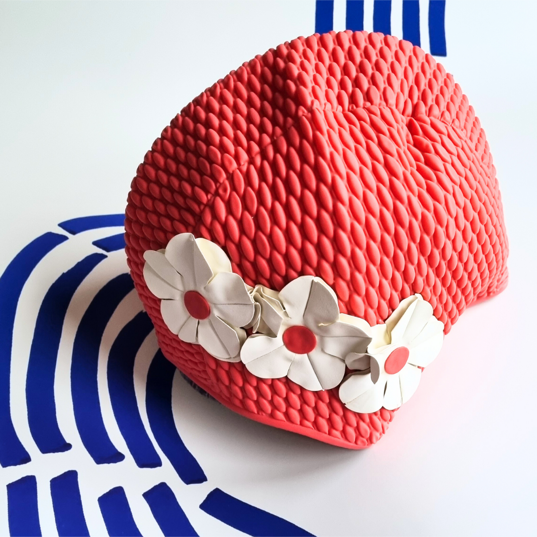 Red retro swim hat with three white flowers on the side
