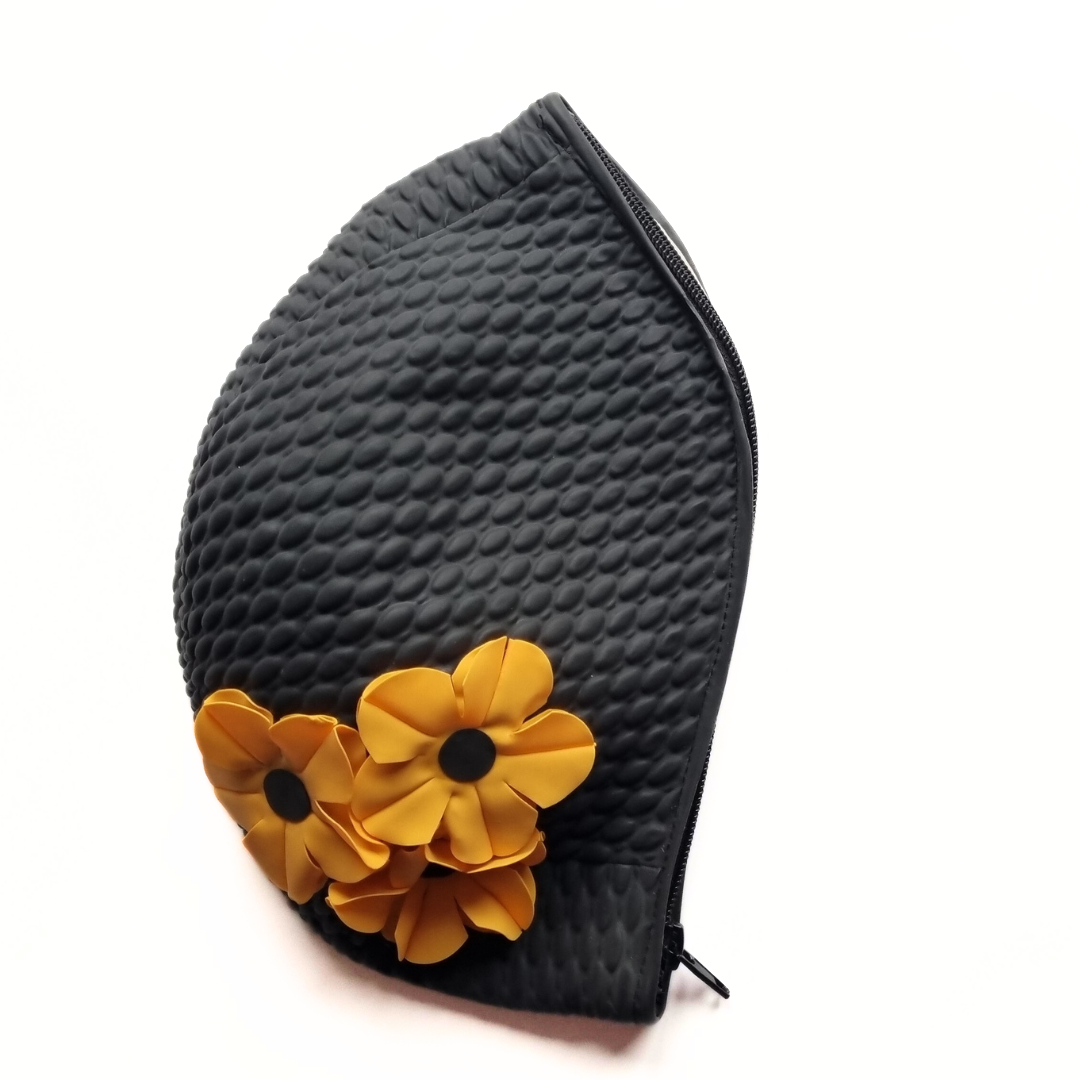 Black retro swim bag made from a vintage style swimming hat. It has three orange flowers on the side.