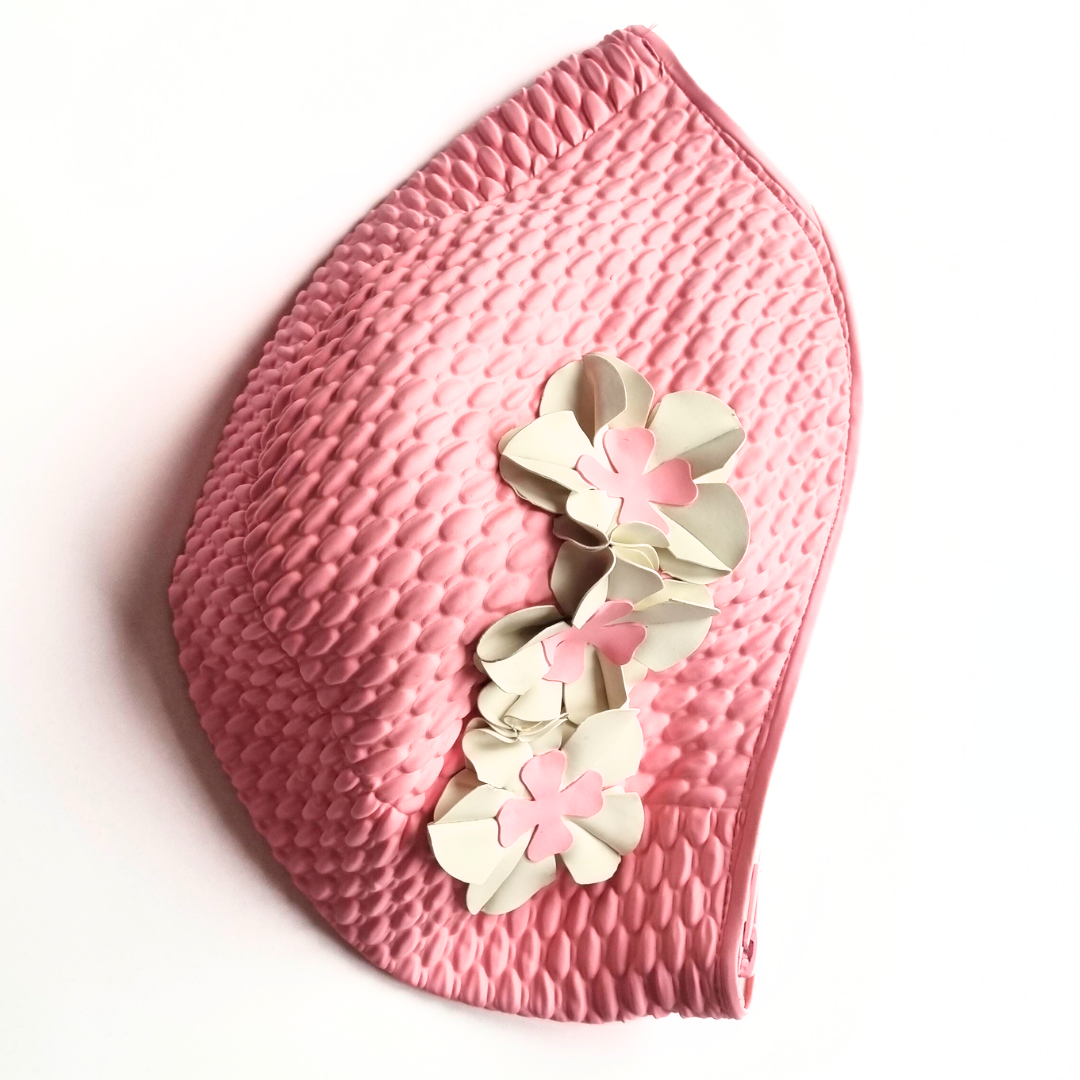 Pink retro swim bag made from a vintage style swimming hat. It has three white flowers on the side.