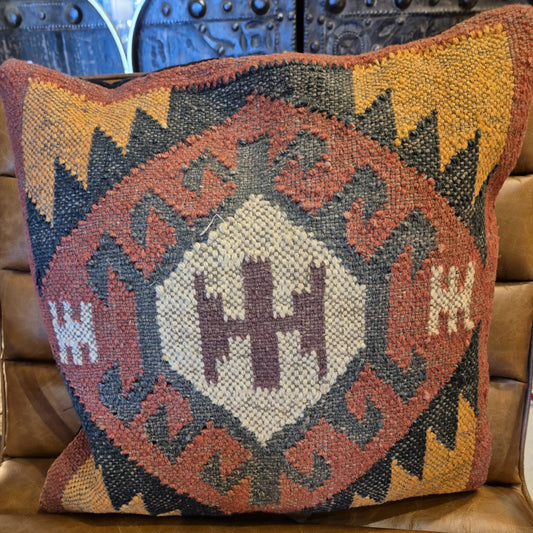 This kilim cushion is made from wool and has a colourful classic geometric pattern coming from the center. Get an instant boho feel with this earthy textile accent cushion.