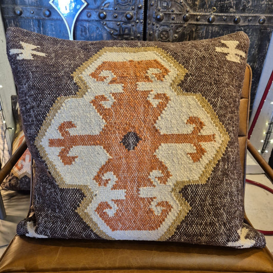 This kilim cushion is made from wool and jute and has a colourful classic geometric pattern coming from the center. Get an instant boho feel with this earthy textile.&nbsp;    55cm x 55cm  Wool and jute