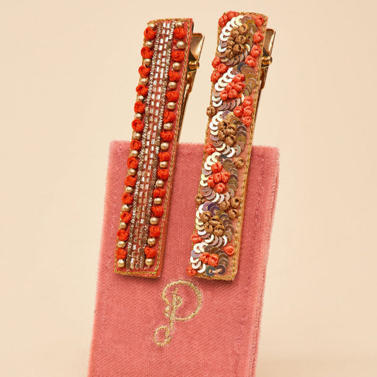 coral jewelled bar clips on a velvet card for the perfect gift