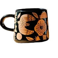 terracotta colour design on black shiny mug