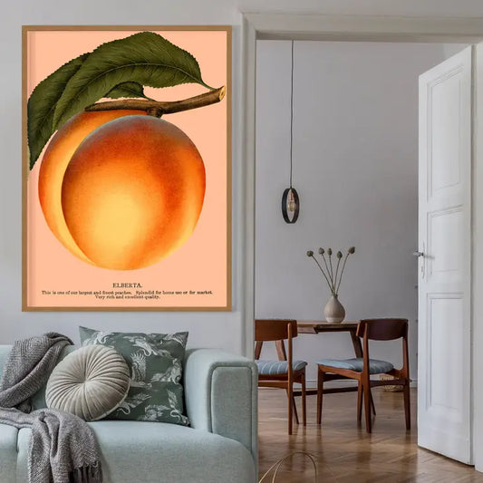 A  large peach takes up most of this print with a stem and leaves at the top and set against a beautiful pale peach background
