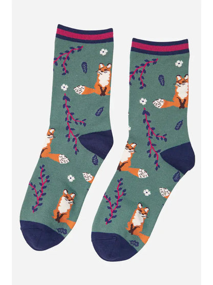 ladies bamboo ankle socks depicting fox and leaf design on a green background