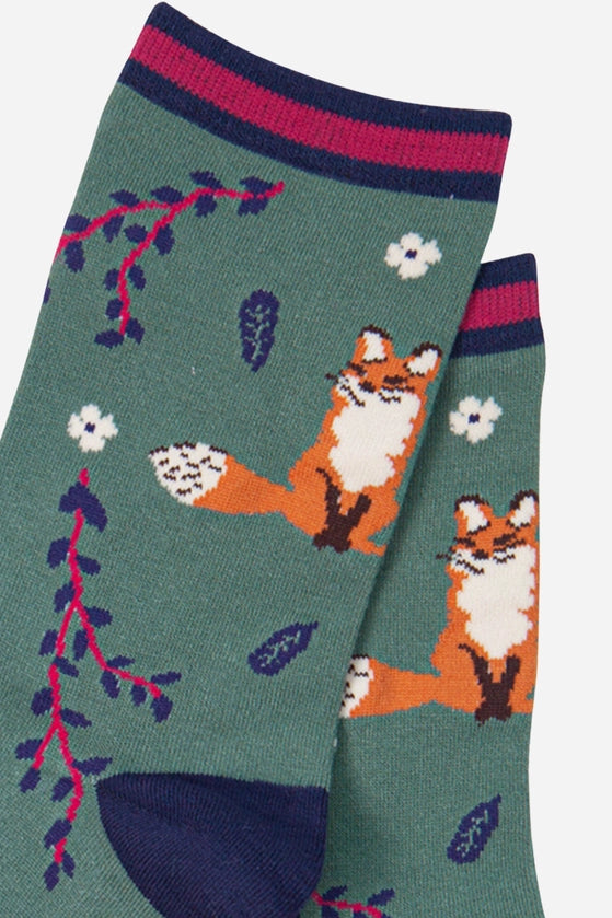 ladies bamboo ankle socks depicting fox and leaf design on a green background