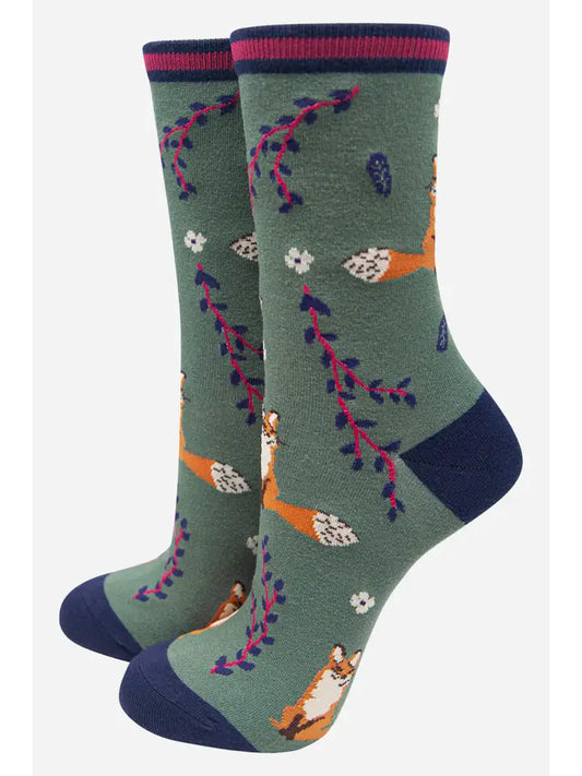 ladies bamboo ankle socks depicting fox and leaf design on a green background