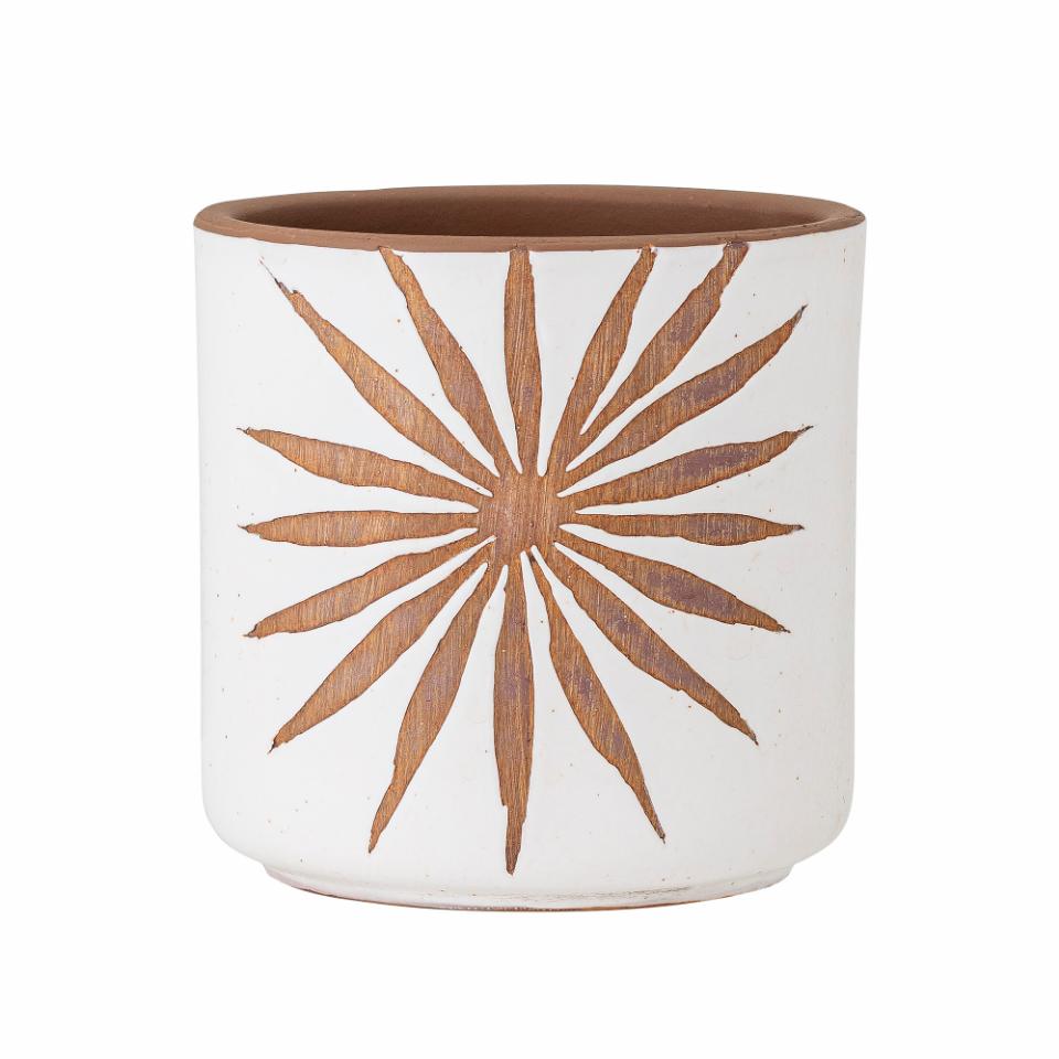 A heavy duty terracotta flower pot with a spiky flower design in a terra colour with a white background