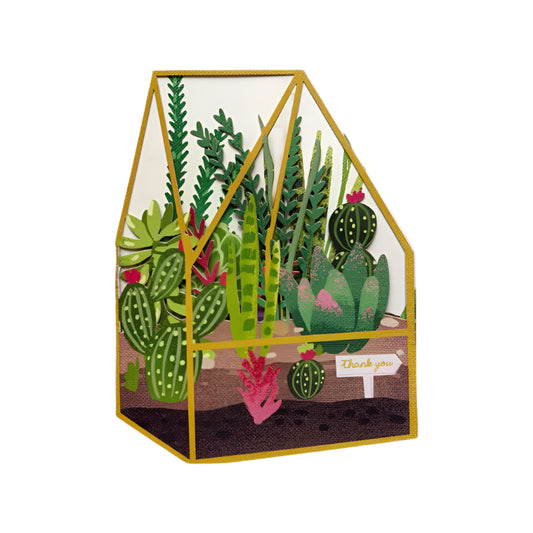 A colourful card featuring a cut out greenhouse