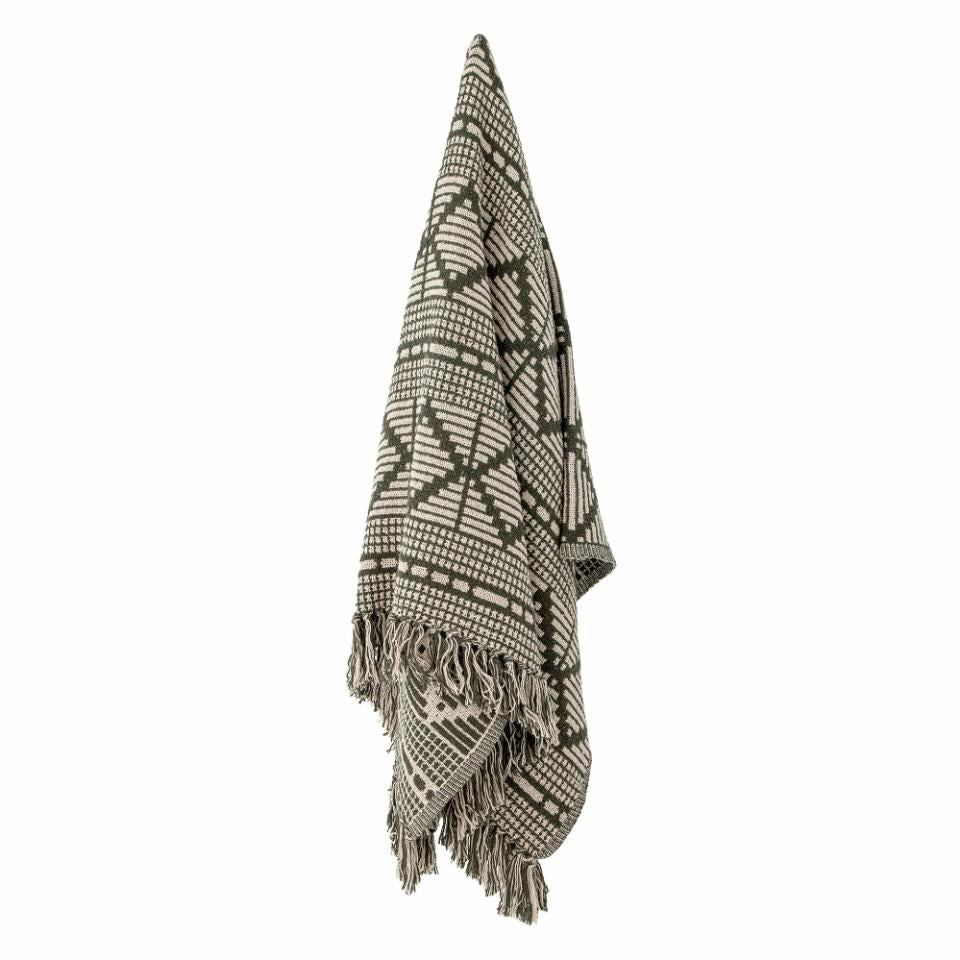 A soft and luxurious throw in gray/green with a decorative pattern and fringe