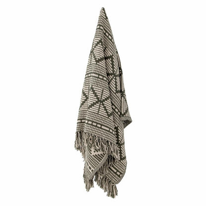 A soft and luxurious throw in gray/green with a decorative pattern and fringe