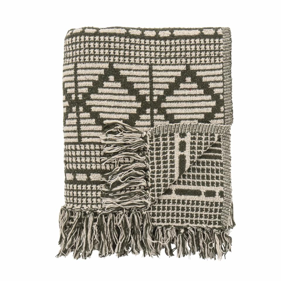A soft and luxurious throw in gray/green with a decorative pattern and fringe