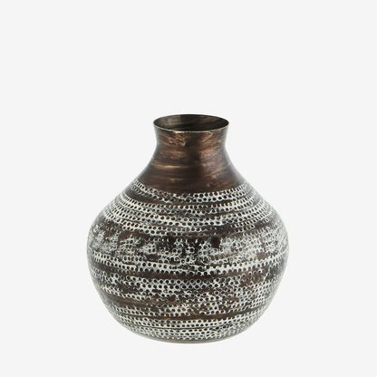 This hammered aluminum vase is not only a stunning piece of home decor, but it also serves as a sustainable and ethical option.