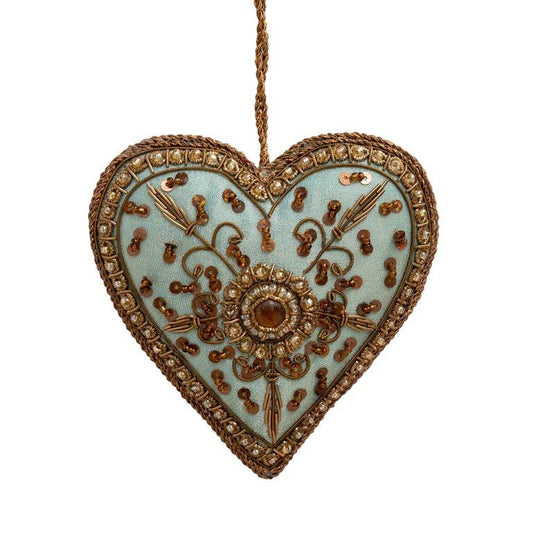 decoration heart embroidered with gold thread on pale green background