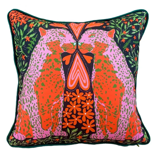 Two leopards in love, pops of pink and orange on a dark background . A luxurious velvet back with hand made velvet piping. pur luxury