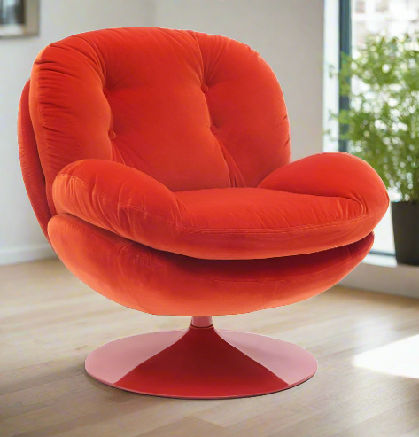 A swivel chair in luxurious vibrant red/orange velvet. It has a heavy circular metal base in the same vibrant colour