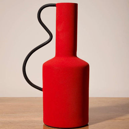 tall red metal graphic vase