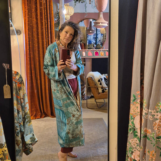 A reversible silk kimono made with vintage up-cycled silk sari fabric. Each side  is completely different and each kimono is completely unique