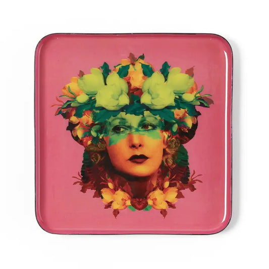 trinket tray with figure of woman's face on pink background