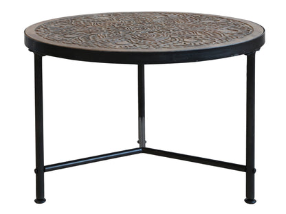 coffee table with intricate carvings on three legs